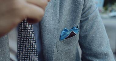 A Stylish and Sophisticated Businessman Dressed in a Classy Gray Suit adorned with a Pocket Square video