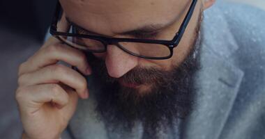 A professional man engaged in a phone conversation while dressed in business attire video