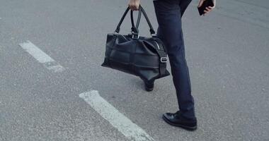 Businessman Casually Walking on a Vibrant Urban Street While Holding a Briefcase video