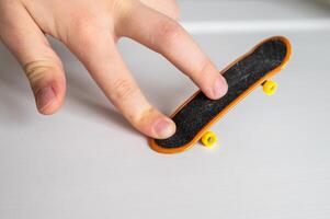 a hand holding a skateboard photo
