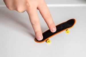 a person's finger on a skateboard photo