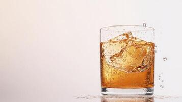 Amber Liquid Splashing in Rocks Glass on White Backgrounds with Ice photo