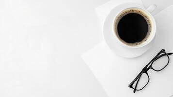 White Coffee Cup Eyeglasses and Papers on White Desk photo