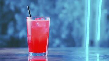 Red Cocktail With Ice And Black Straw In Blue Neon Light Setting photo