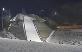 Illuminated Ski Jump Ramp at Night photo