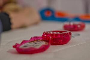 Close-Up of a Pink Toy Case with White Pieces photo