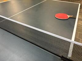 Close-Up of Table Tennis Setup with Paddle photo