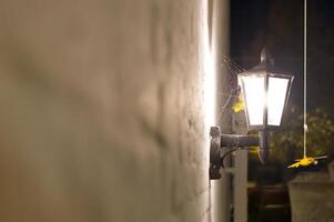 Illuminated Vintage Lantern with Spider Web at Night photo