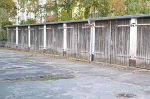 Row of Wooden Garage Doors in Autumn Setting photo