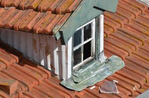 Weathered Rooftop with Dormer Window photo