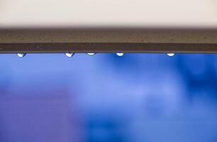 Water Droplets on a Ledge with Blue Background photo