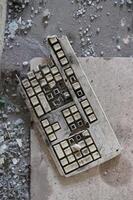 Abandoned Old Keyboard on a Dirty Floor photo