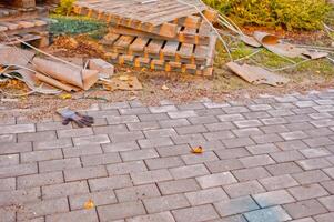 Construction Site with a lost glove and Pallets and Paved Pathway. photo