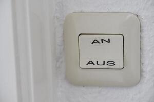 Close-up of Light Switch with German On and Off Labels photo