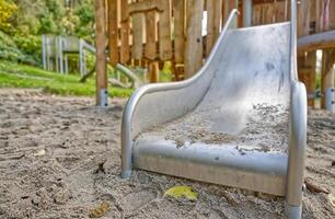 Close-Up of a Playground Slide in Sand photo