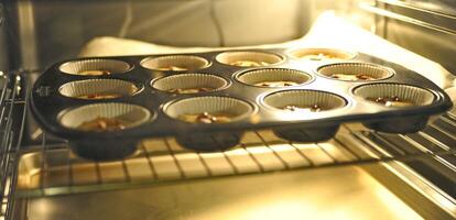 Muffin Tray Baking in Oven photo