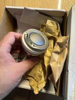 Unboxing a damaged Metallic Sink drain in a Cardboard Box photo