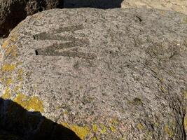 Textured Rock with Carved Letter M photo
