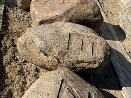 Weathered Rock with Carved Markings photo
