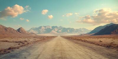 an empty dirt road in the middle of a desert photo