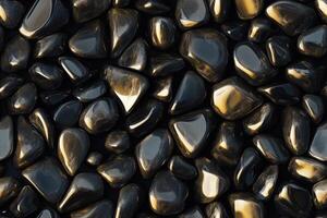 Seamless Gold Obsidian smooth, polished black pebbles arranged closely together, showcasing their shiny surfaces and varied shapes. photo