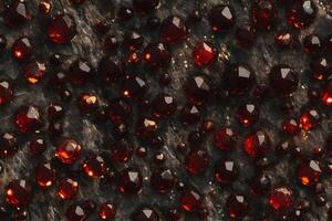 A close up of red gems on a stone surface photo