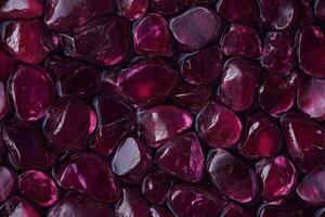 A close up of red stones in a pool photo
