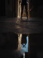 Anonymous ballet dancer near puddle photo