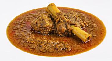 A plate with a bowl of stew with two sticks photo