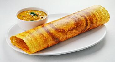 A plate with a crepe and a bowl of sauce photo