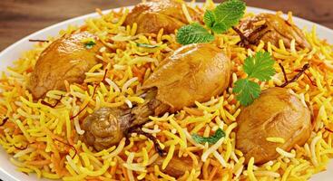 A plate of chicken biryani with carrots and parsley photo