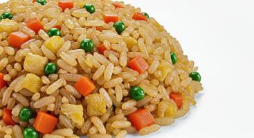 A pile of rice with vegetables and peas photo