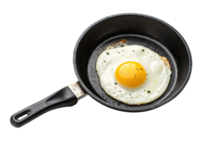 A perfectly cooked egg with a golden yolk in a black skillet, garnished with ground pepper and herbs for a simple, appetizing meal png