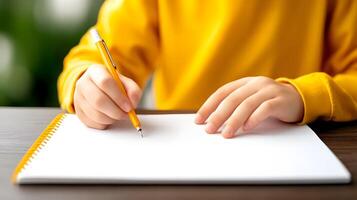 A student writing in a notebook, focused on their studies in a classroom photo