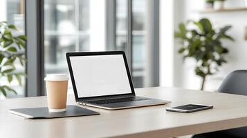 High-end workspace mockup with laptop, tablet, smartphone, and coffee cup on glass table photo
