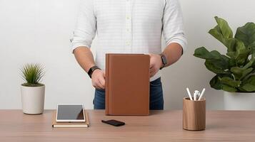 A flat-lay of productivity essentials including a notebook, tablet, phone, and wireless earbuds on a wooden table photo