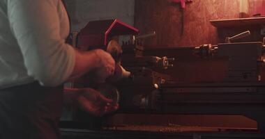 Mechanic using lathe for metal processing video