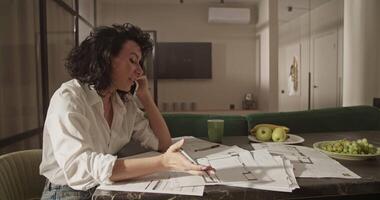 Female architect discussing drafts with client video