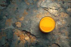 Orange juice in a glass on a cracked surface photo