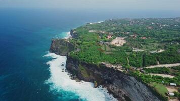 Uluwatu coastline with cliffs, rock and ocean with waves in Bali. Scenic drone landscape in Bukit video