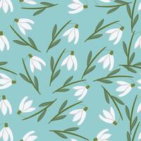 Delicate snowdrop flowers and leaves create a beautiful seamless pattern vector
