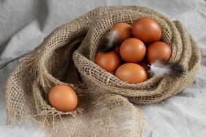 Eggs in a burlap bag on a white background,Happy Easter concept. photo
