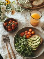 Fresh avocado toast with cherry tomatoes and arugula, served with orange juice. vibrant and healthy breakfast option, perfect for sunny morning photo
