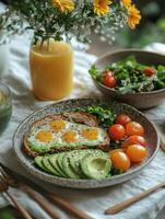 Delicious breakfast featuring avocado toast topped with eggs, cherry tomatoes, and fresh salad. vibrant and healthy meal, perfect for starting day with energy photo