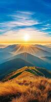 breathtaking sunrise over rolling mountains, with golden rays illuminating landscape and soft grass in foreground, creating serene and peaceful atmosphere photo