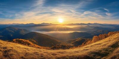 breathtaking sunrise over mountainous landscape, showcasing rolling hills, golden grass, and misty valley below. warm light creates serene and tranquil atmosphere photo