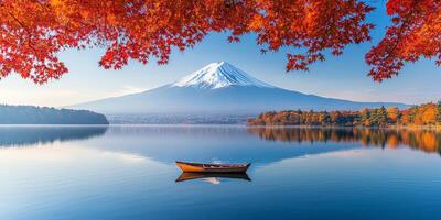 Scenic view of Mount Fuji with autumn foliage reflecting in calm water, creating serene atmosphere. small boat floats peacefully in foreground photo