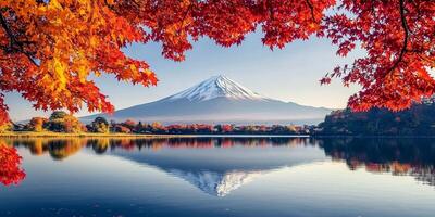 Mount Fuji reflected in serene lake, surrounded by vibrant autumn foliage photo