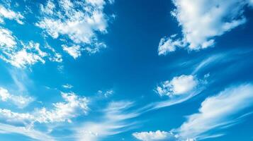 Bright blue sky with fluffy white clouds creating serene atmosphere. gentle wisps of clouds add touch of beauty to clear day photo