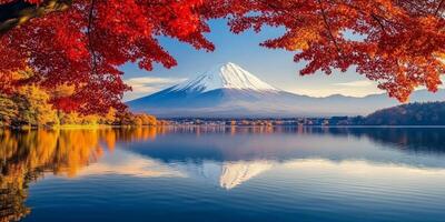 Majestic Mount Fuji reflected in serene lake surrounded by vibrant autumn foliage. scene captures beauty of nature in tranquil setting photo